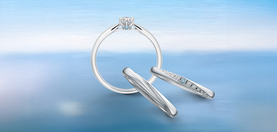 〈エトワール〉<br />
ひときわ輝くたった一つの光をとりまく無数の星々。<br />
どこまでも続く青い空と海に、星のような煌めきを重ねて。ふたりの愛が、澄んだ青の中でいつまでも輝き続けますように。